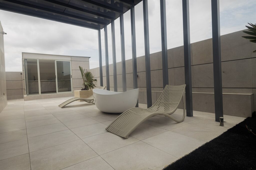 Brum Height 6: Rooftop terrace with loungers beneath a pergola